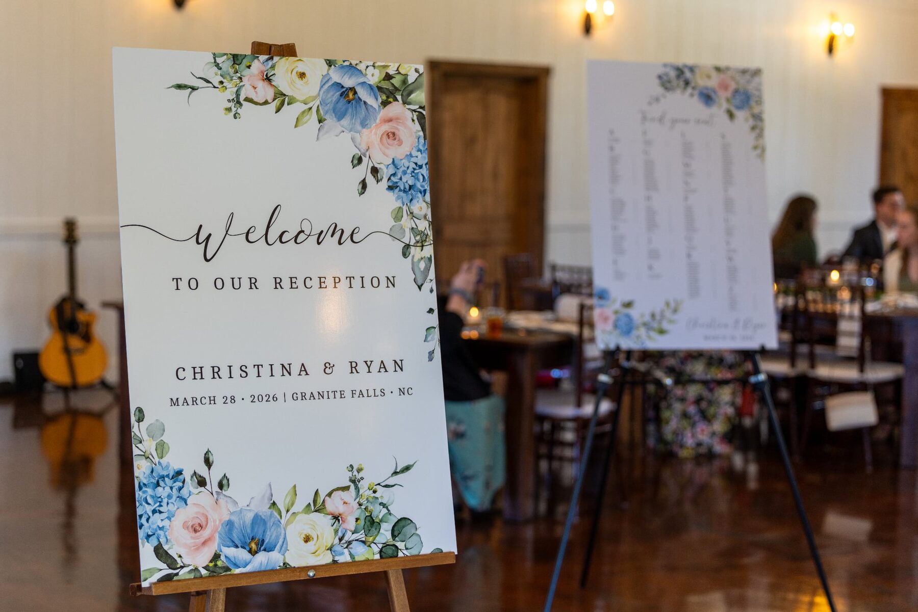 A welcome sign and a seating chart on easels at a wedding reception, printed by Howling Press